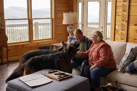 Farm owners interact with dogs in vacation second home financed by Rural 1st