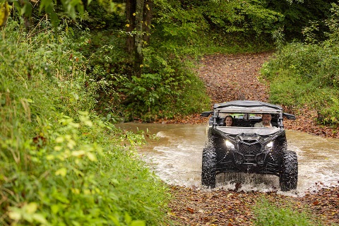 Man and woman ride ATV on land financed by Rural 1st